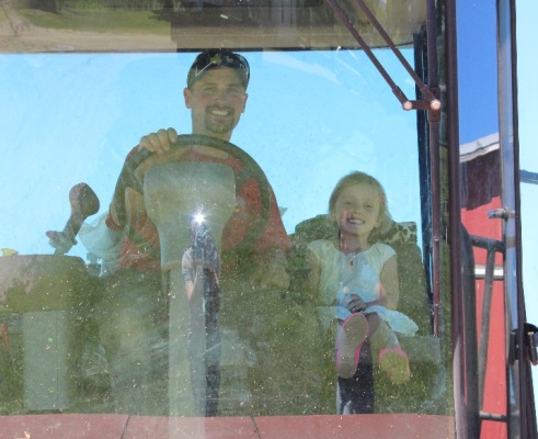 Robby and Olivia Dygert on a tractor on their farm in Palatine Bridge.