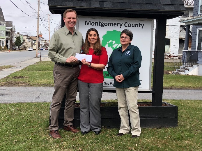 David Jordan, Sara Boerenko, and Wendy Proctor pictured Tuesday with a check that was donated to the OFA food pantry.