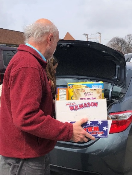 OFA Case Manager Steve Prohaska unpacks non-perishables being delivered to the OFA food pantry Tuesday.