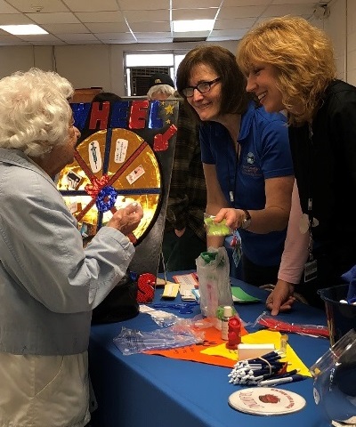 D. Dorine Dimond, of Fonda, plays a game Thursday with Immunization Coordinator Wanda Antos and Community Health Nurse Suzanne Skelton during the Public Health Department's Senior Meet and Greet. 