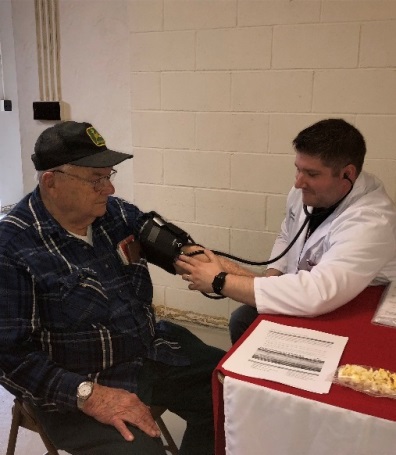 Pharmacist Joshua Baker checks Allan Taylor's blood pressure Thursday during the Public Health Department's Senior Meet and Greet.