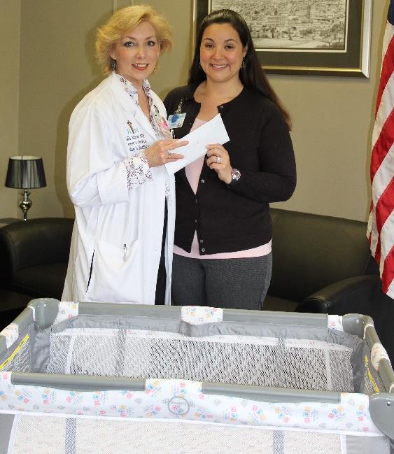 Director of Women’s Services Julia Shafer, MSN, of St. Mary’s Healthcare and
Montgomery County Public and Mental Health Director Sara Boerenko pictured with the
county’s Jeans Day donation to support Cribs for Kids.