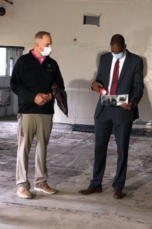 County Executive Matthew L. Ossenfort and U.S. Rep. Antonio Delgado D-19th look at photos of demolition progress during a tour Tuesday of the Exit 29 Redevelopment Project.