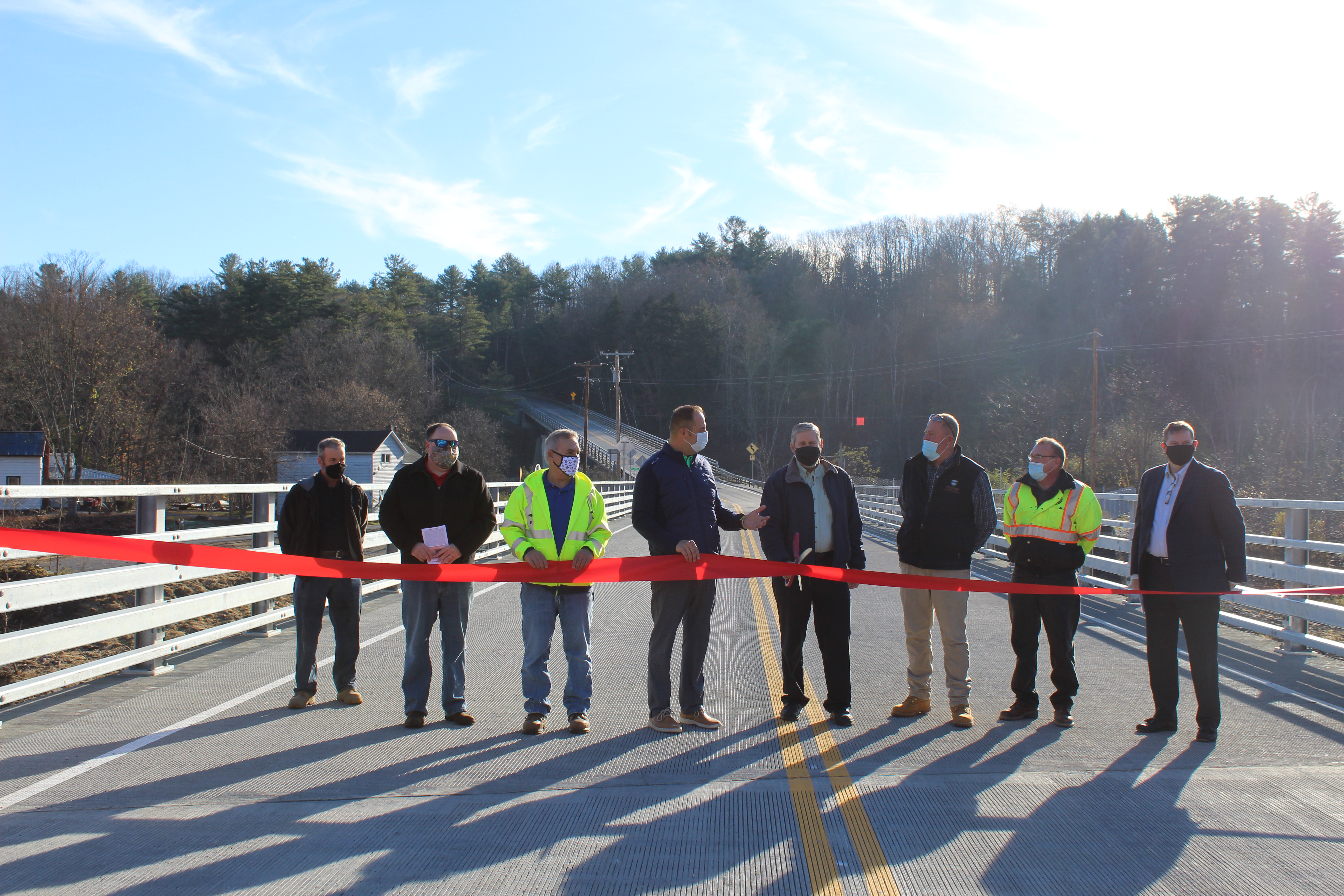 Former Department of Public Works Commissioner Paul Clayburn cuts the ribbon for the new Burtonsville Road Spur Bridge during a ceremony Thursday.